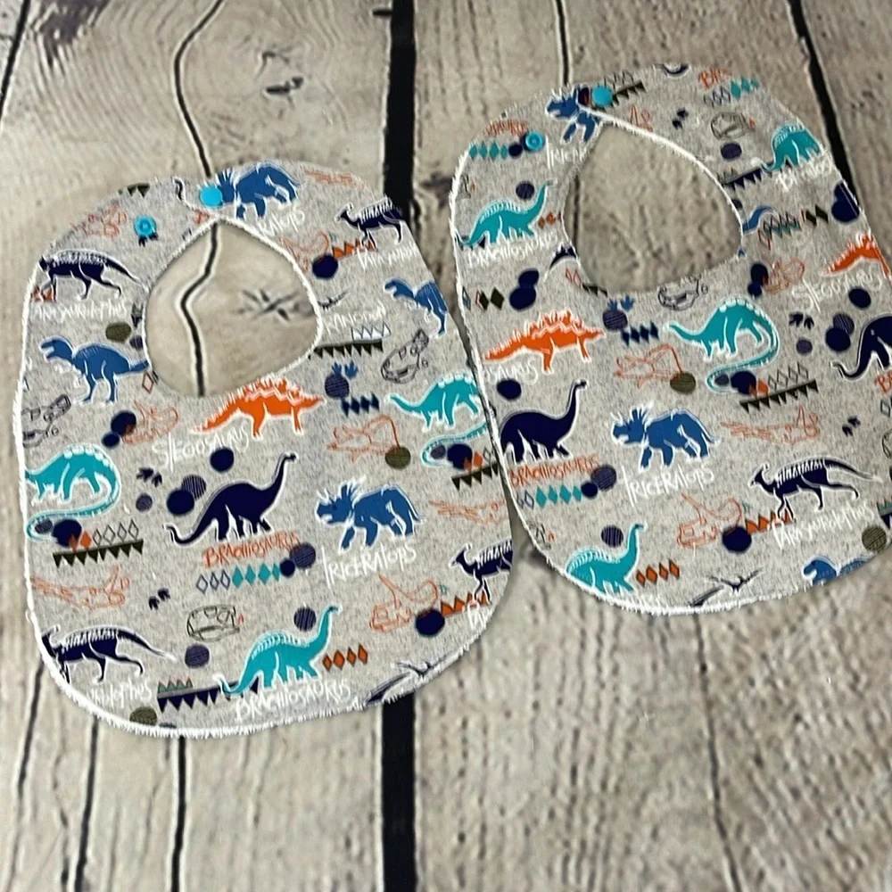 Designer handcrafted dinosaur bib